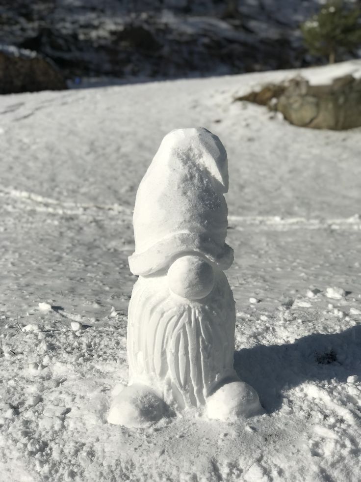 a snow man is sitting in the snow