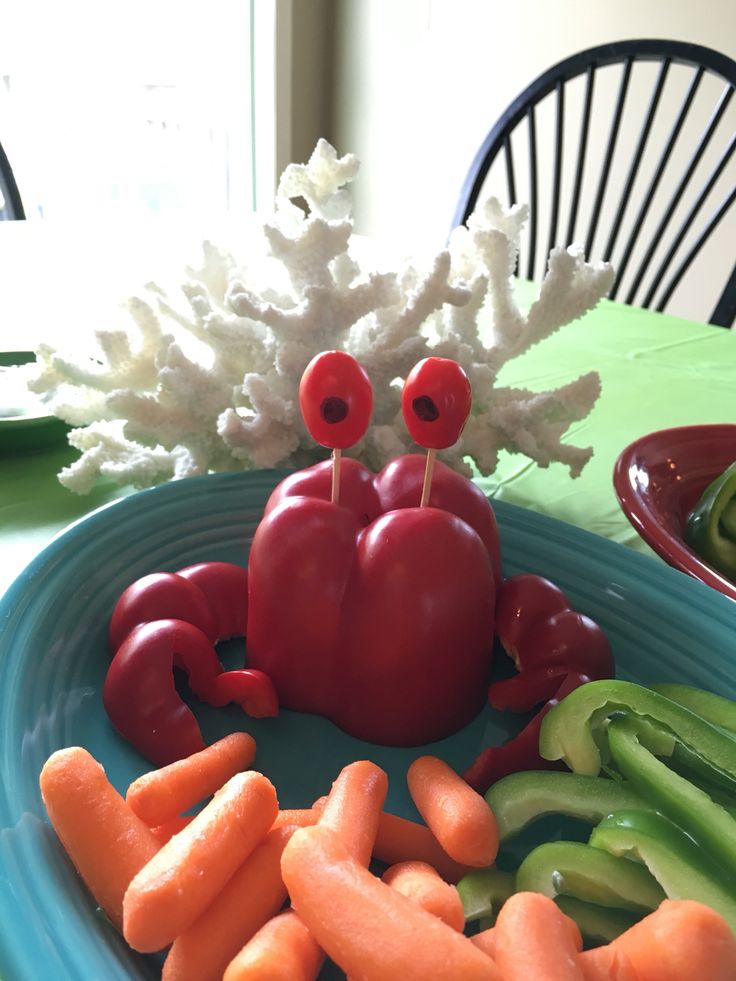 a plate with carrots, celery and peppers in it on a table