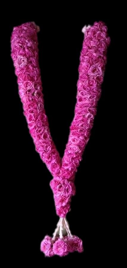 the letter v is made out of pink flowers