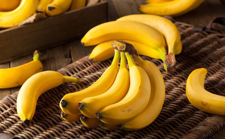 several bunches of bananas sitting on top of a wicker basket next to each other