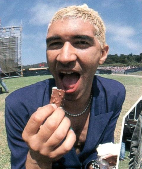 a man with his mouth open and eating something in front of him on the field