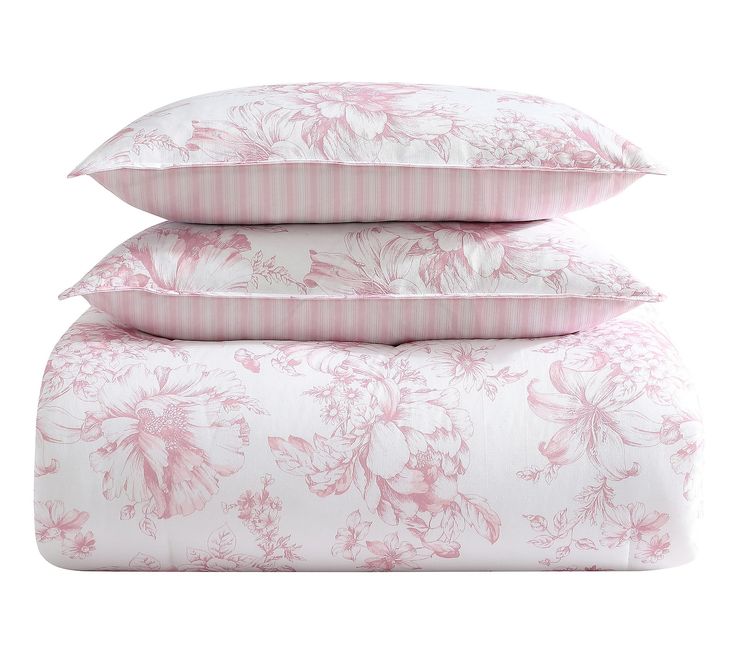 three pillows stacked on top of each other with pink and white floral designs in them