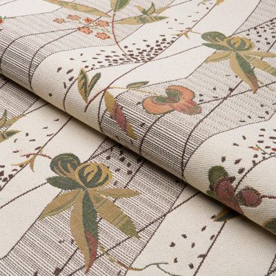 an upholstered fabric with flowers and leaves on it