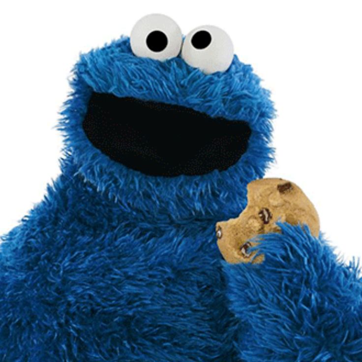 a blue stuffed animal with big eyes holding a cookie