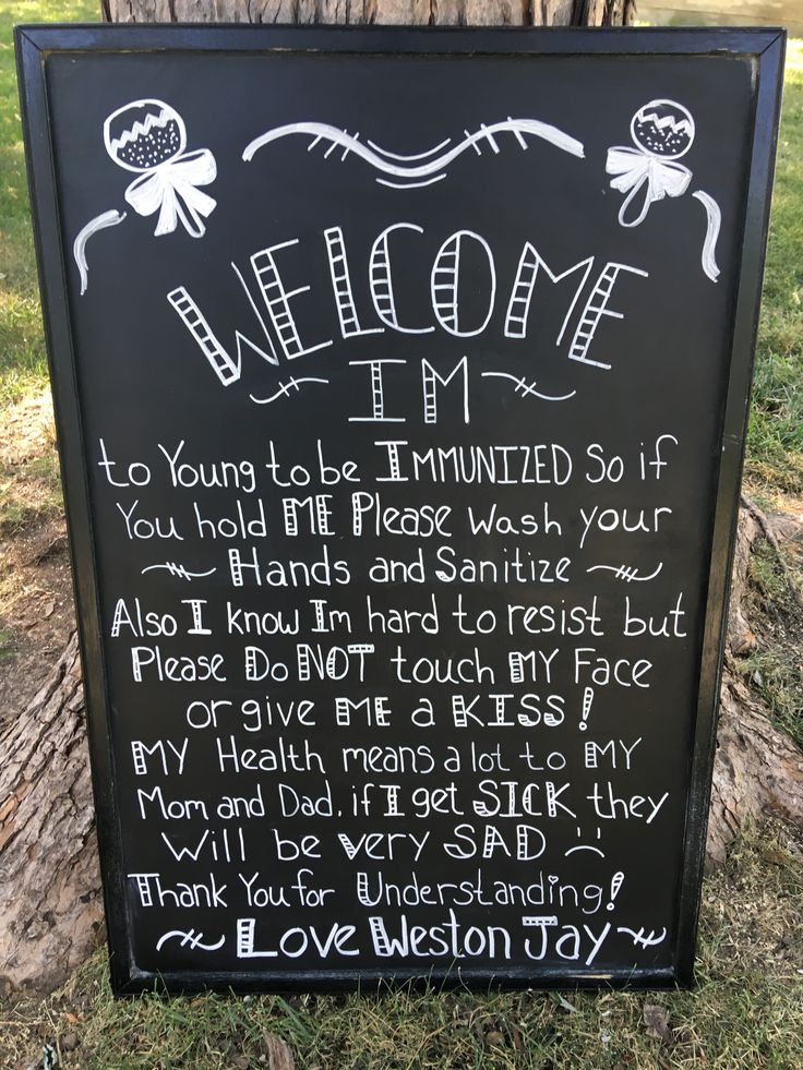 a welcome sign in front of a tree