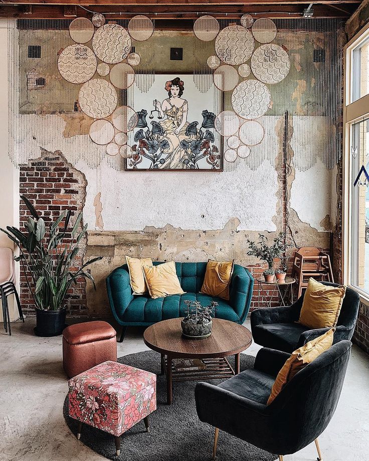 a living room filled with furniture next to a brick wall covered in circles and flowers