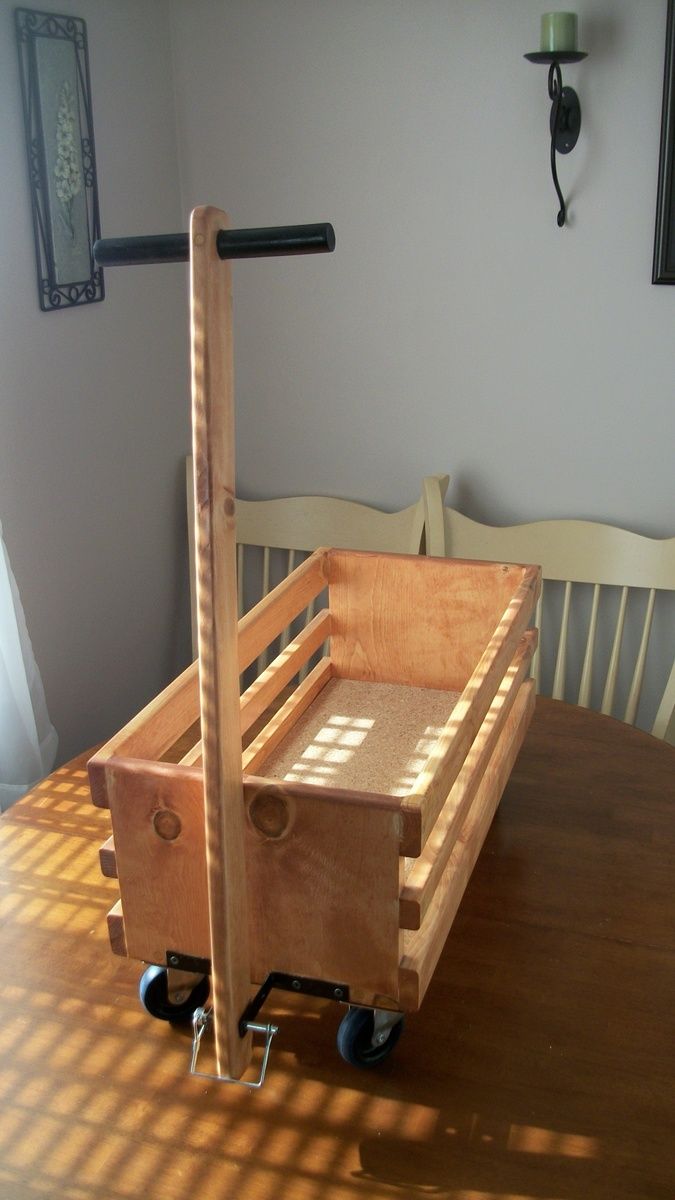 a wooden cart sitting on top of a wooden table