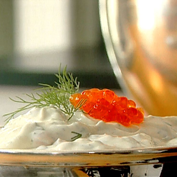 a plate with some food on top of it and a glass cup in the background