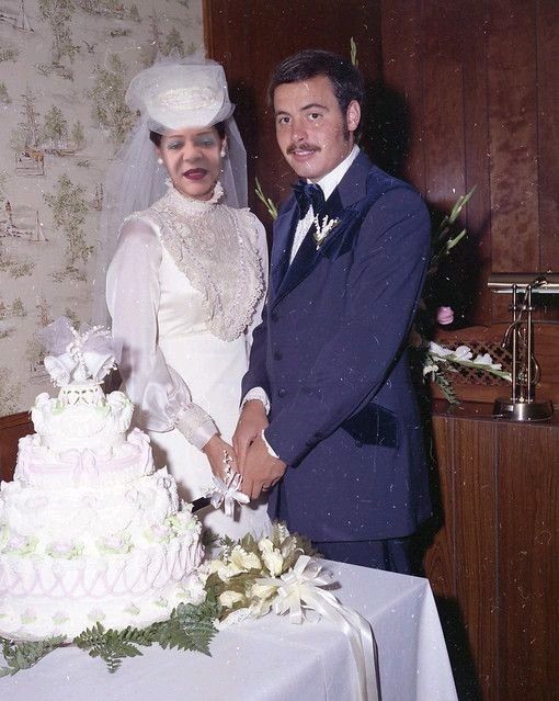 a bride and groom cutting their wedding cake