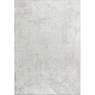 a white rug with an abstract design on the top and bottom, in grey tones