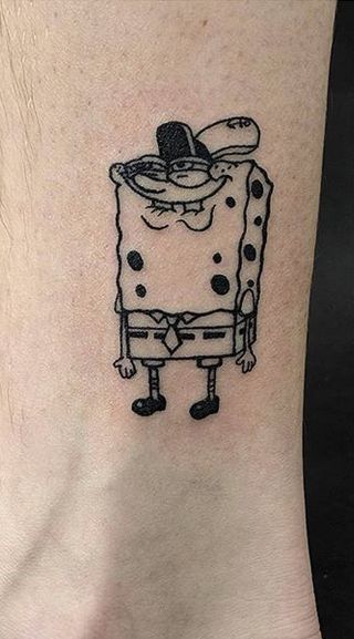 a cartoon character tattoo on the ankle