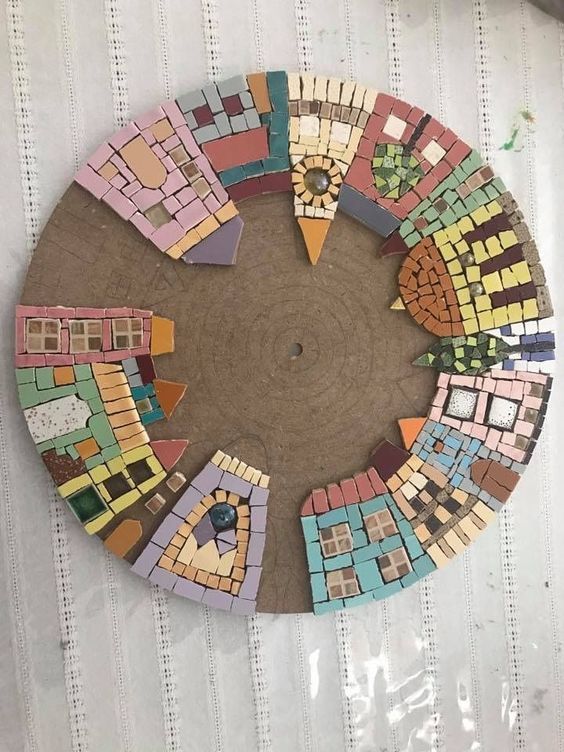 a circular piece of art made out of colorful tiles