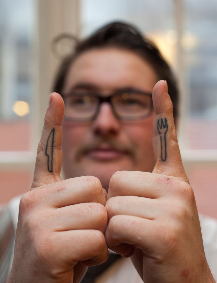 a man holding two fingers up in the air