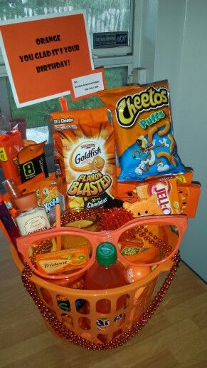 an orange basket filled with snacks and candy