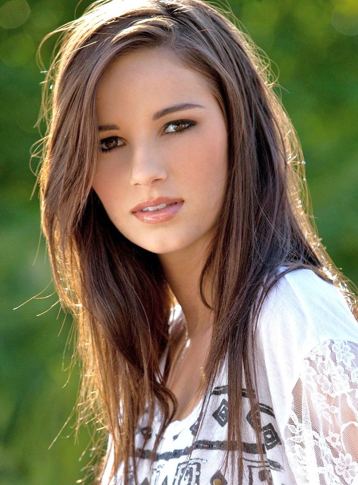 a beautiful young woman with long brown hair