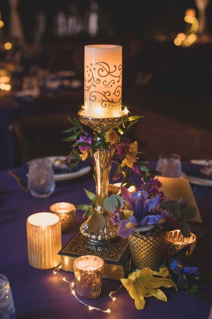 a table with candles and flowers on it