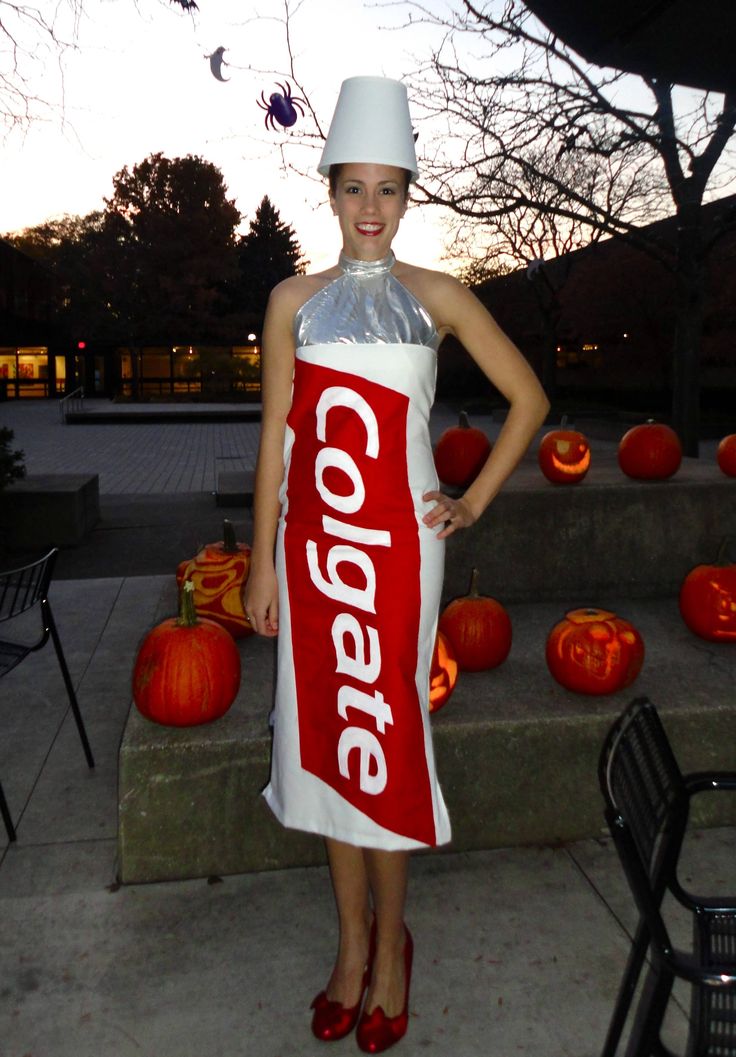 a woman standing in front of pumpkins wearing a diet coke costume