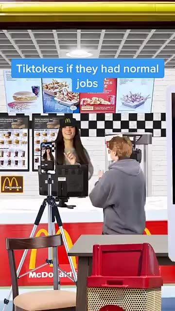 a man and woman standing in front of a fast food stand