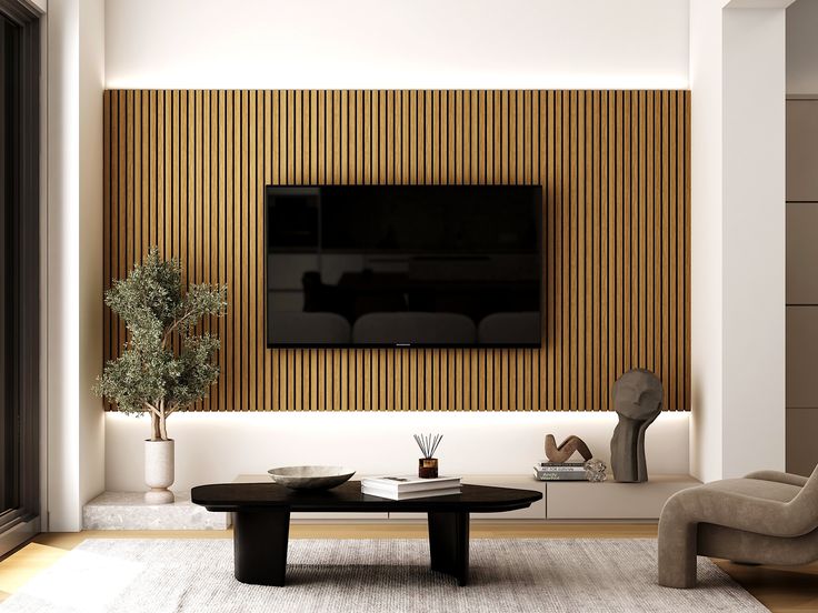 a living room with a couch, coffee table and television mounted on the wall above it