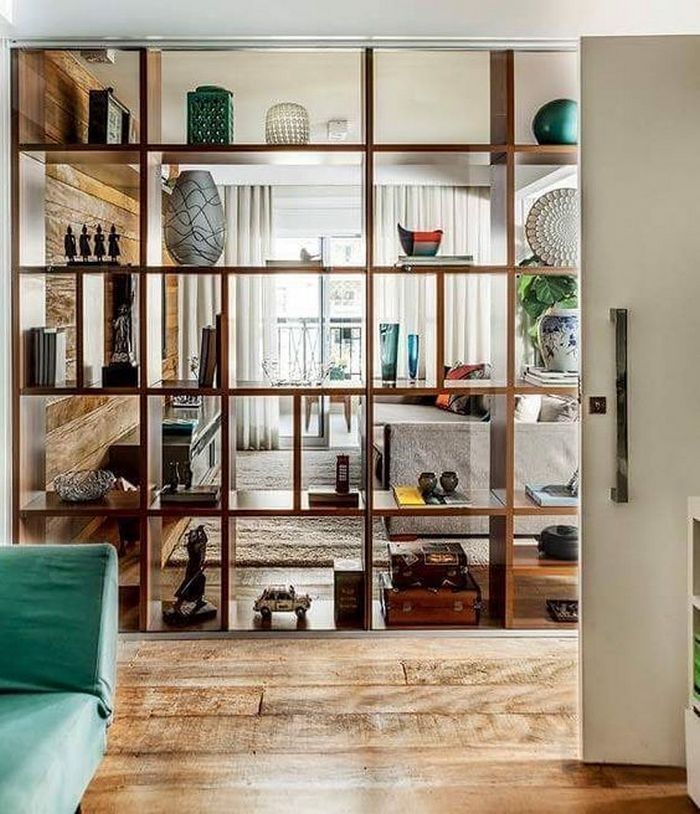 a living room filled with furniture and lots of glass doors that open to the outside