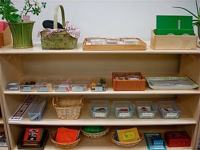 a shelf filled with lots of books and baskets