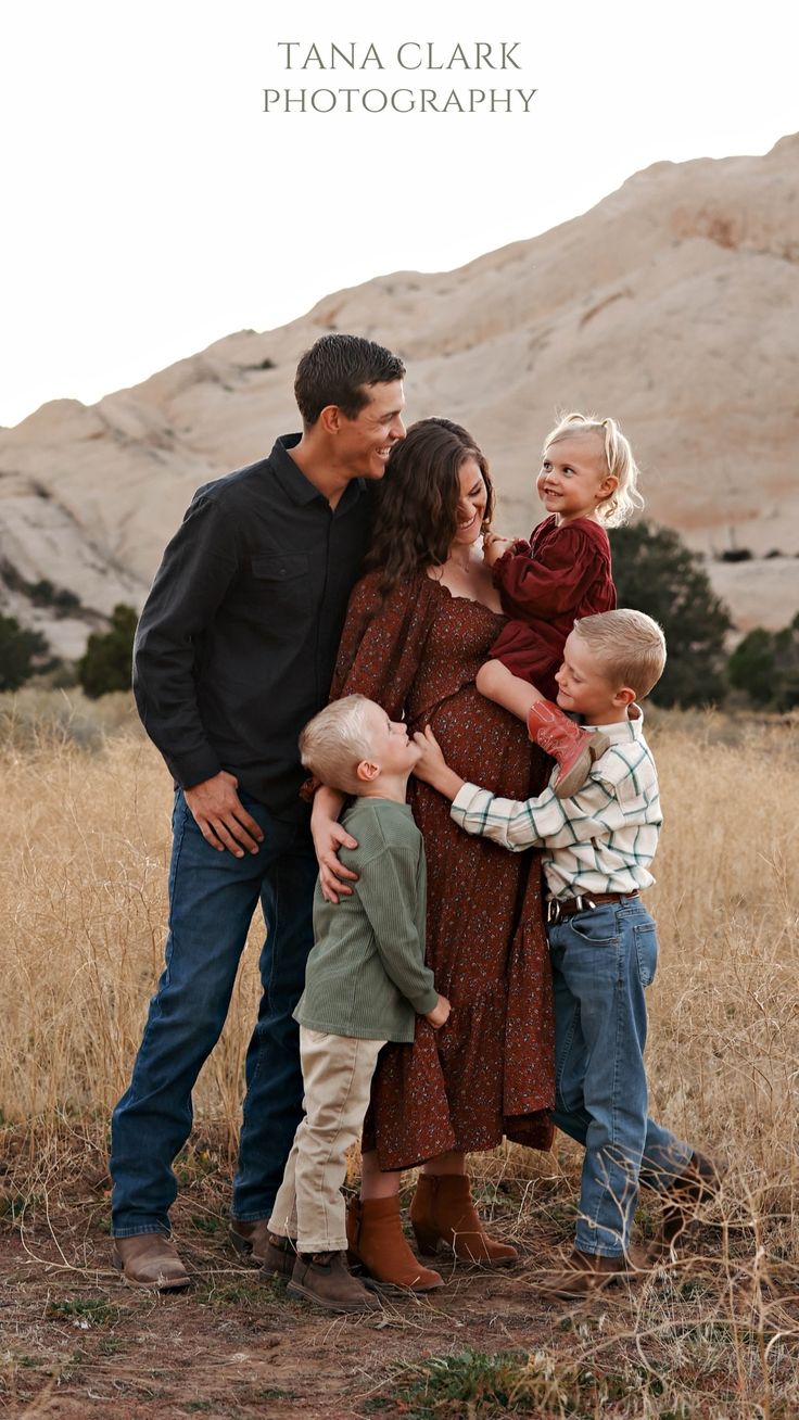 a family posing for a photo in front of a mountain range with the caption tana clark photography