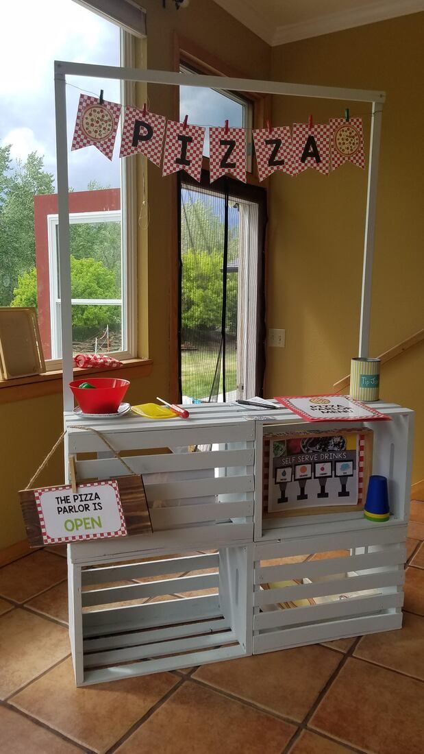 a pizza hut made out of pallets on the floor in front of a window