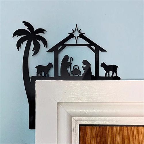 a nativity scene is displayed on the wall next to a door with a palm tree