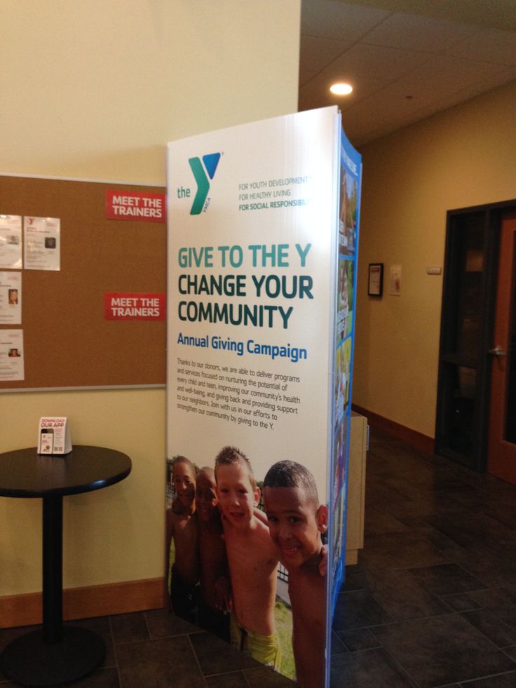 a table with a sign that says give to the y change your community on it