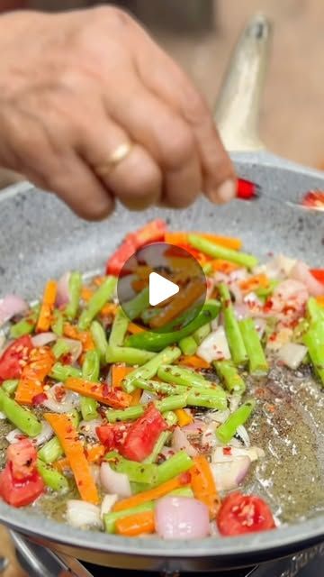 someone is cooking vegetables in a pan on the stove