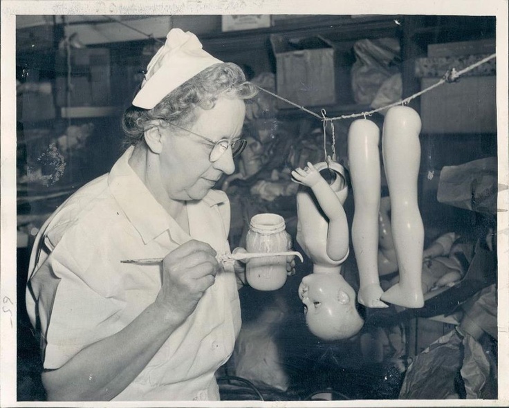 an old black and white photo of a woman working