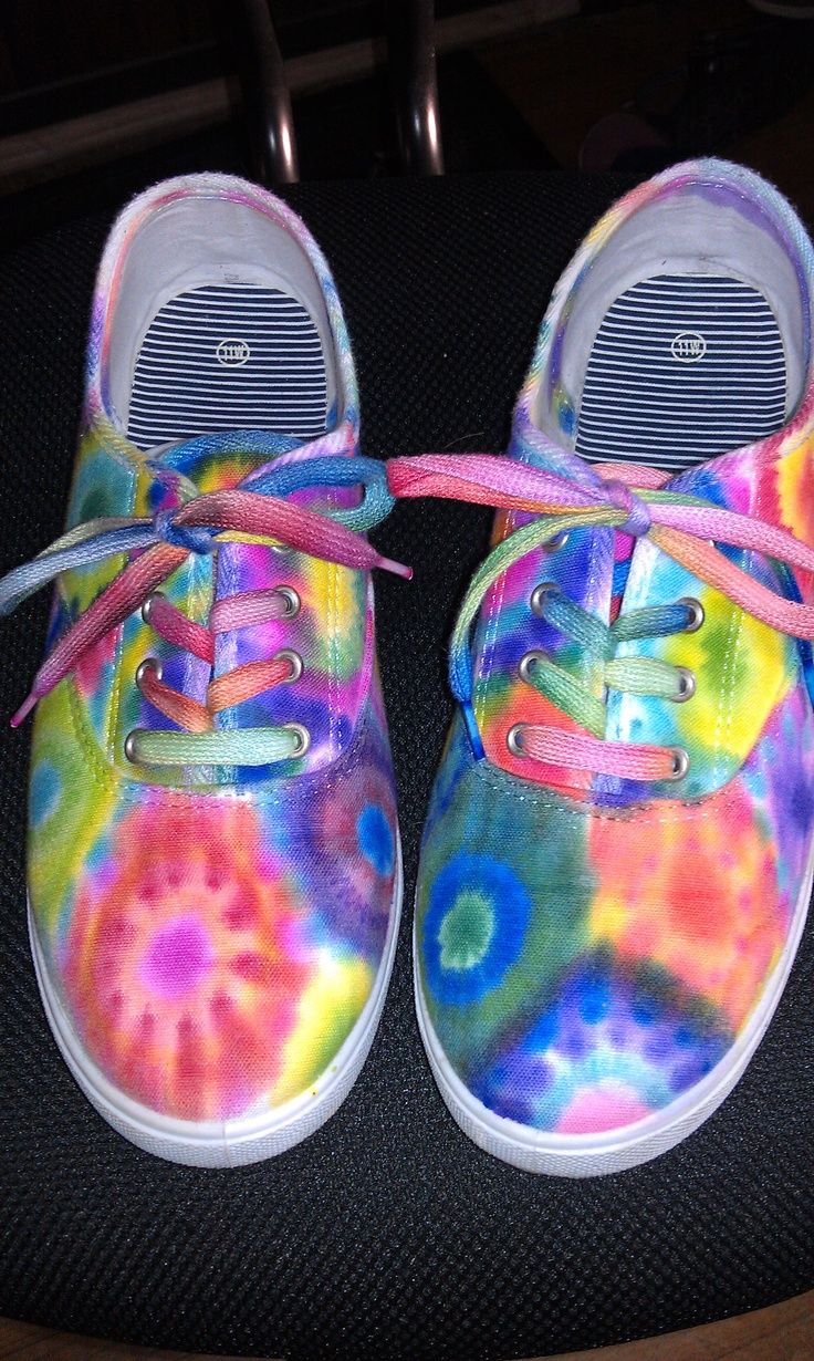 a pair of colorful tie - dyed shoes with pink laces