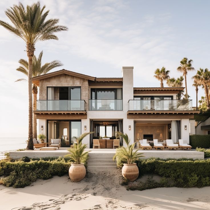 a large house on the beach with palm trees