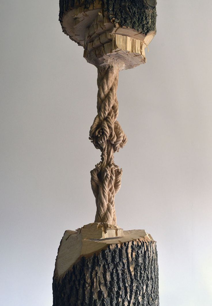 a sculpture made out of rope and wood on top of a tree stump in the shape of a tower