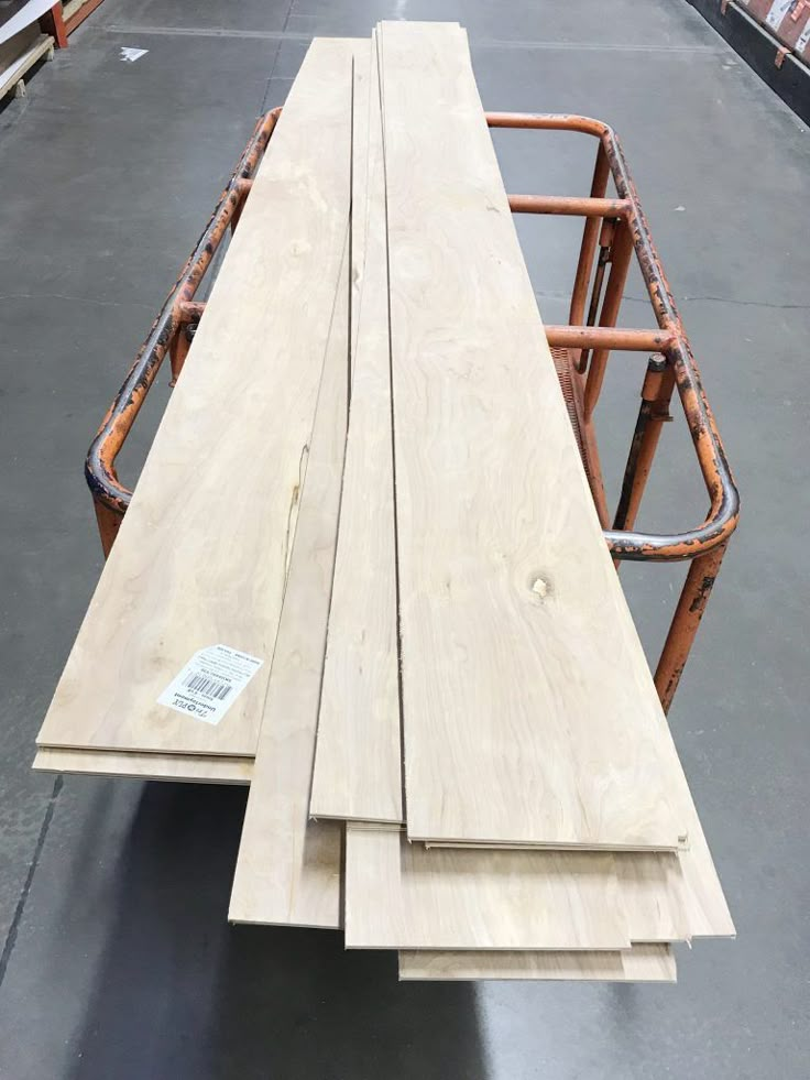 three pieces of plywood sitting on top of each other in a storage area at a warehouse