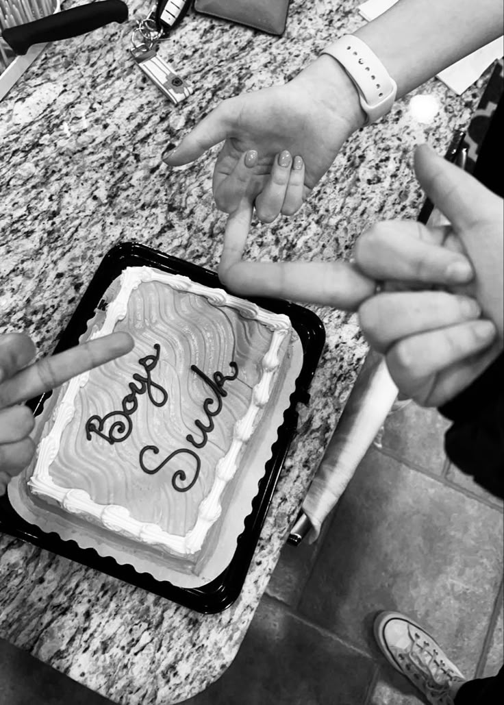 a group of people standing around a cake with the words happy birthday written on it