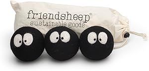 three black balls with googly eyes are in front of a white bag that says, friendsheep sustenable goods