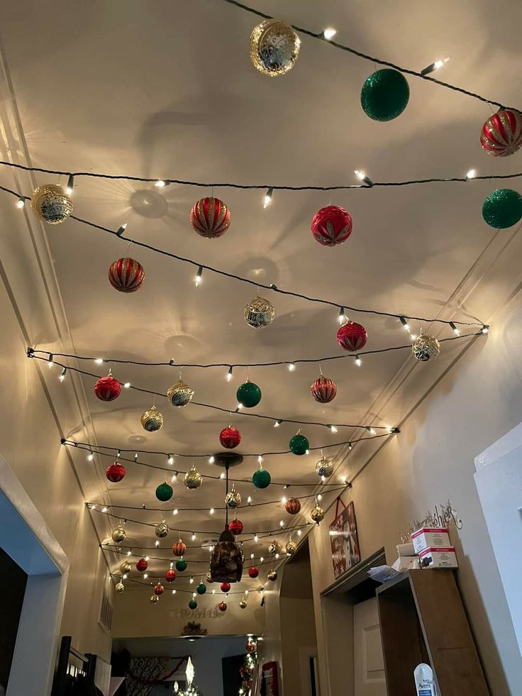 the ceiling is decorated with christmas lights and ornaments