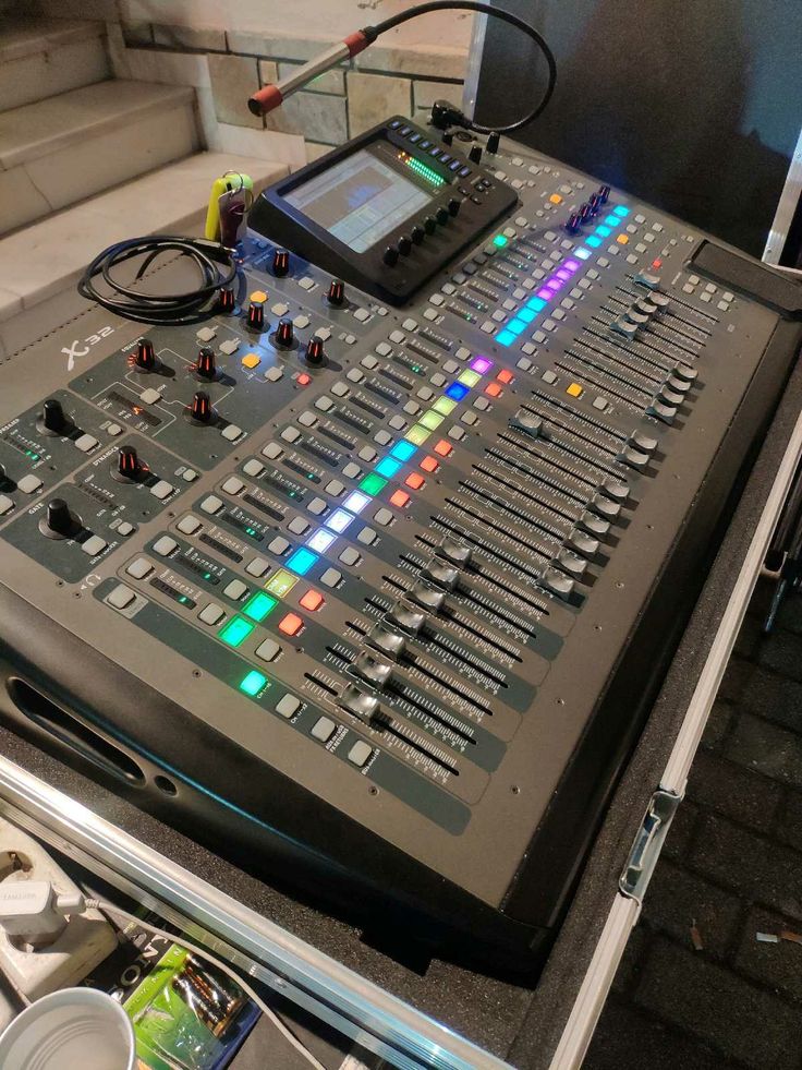 an electronic mixing console sitting on top of a table