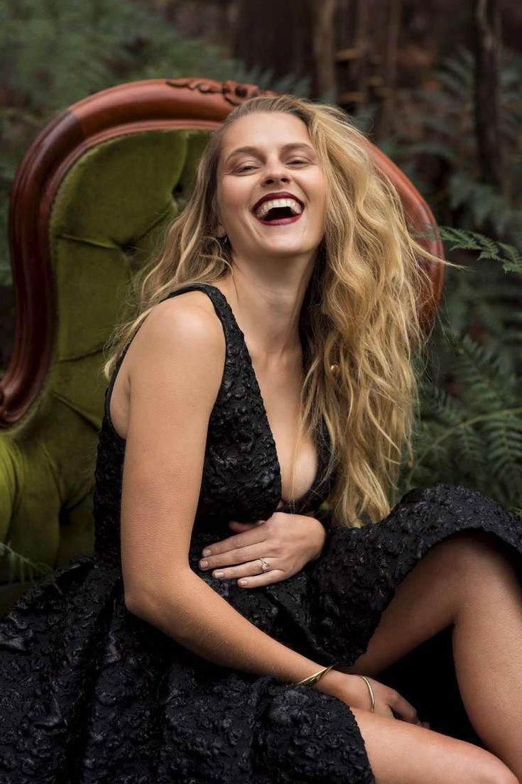 a woman sitting on top of a green chair