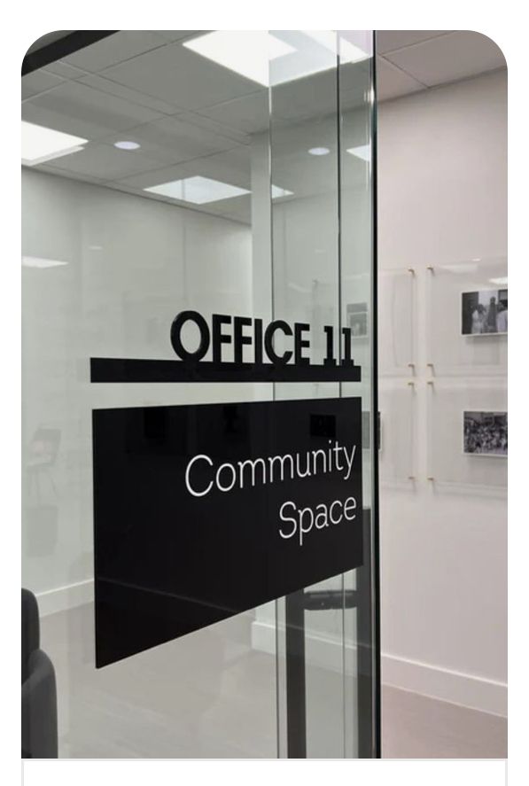 office 11 community space sign in glass door with black and white lettering on the side