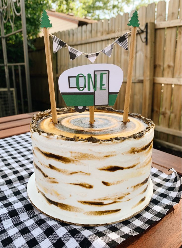 a cake that is sitting on top of a table with a one sign on it