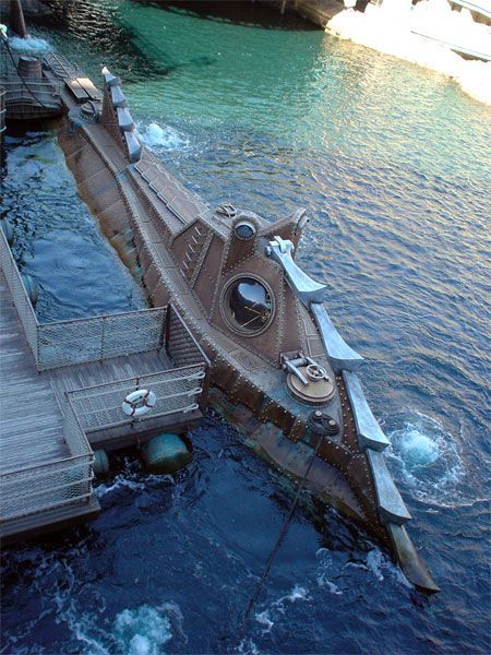 a submarine floating in the water next to a dock