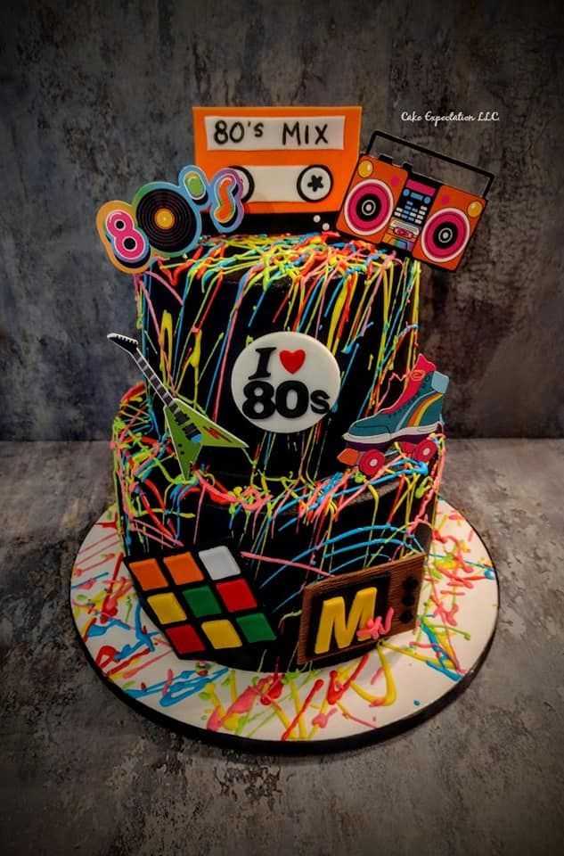 a birthday cake decorated with the 80's music theme