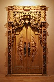 an intricately carved wooden door in a room