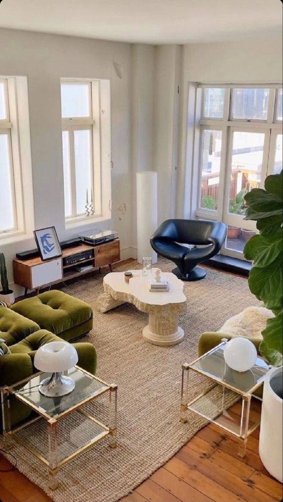 a living room filled with furniture and lots of window sill space next to each other