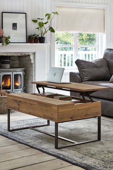 a living room with a couch, coffee table and fireplace