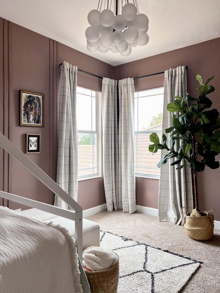 a bedroom with pink walls and white curtains