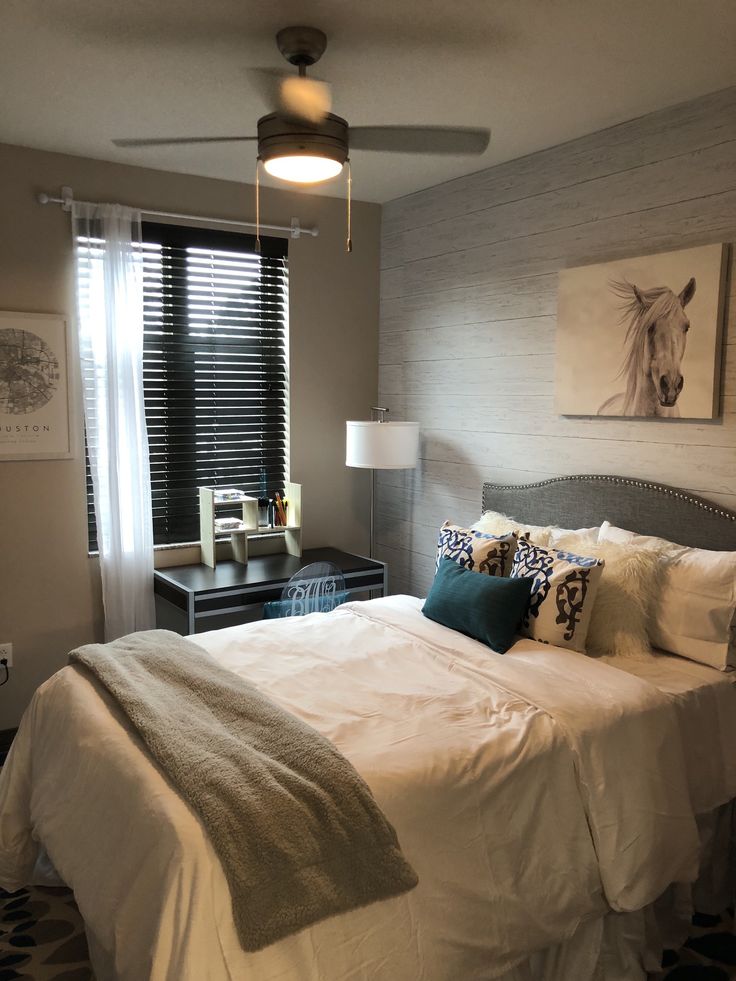 a bedroom with a bed, nightstands and window in it's center area