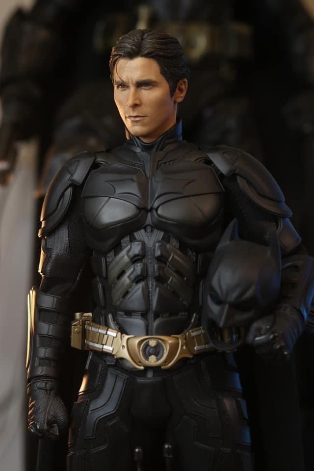 the action figure is dressed in black and gold